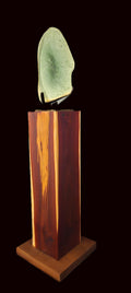 Freeform jade sculpture mounted on hardwood plinth