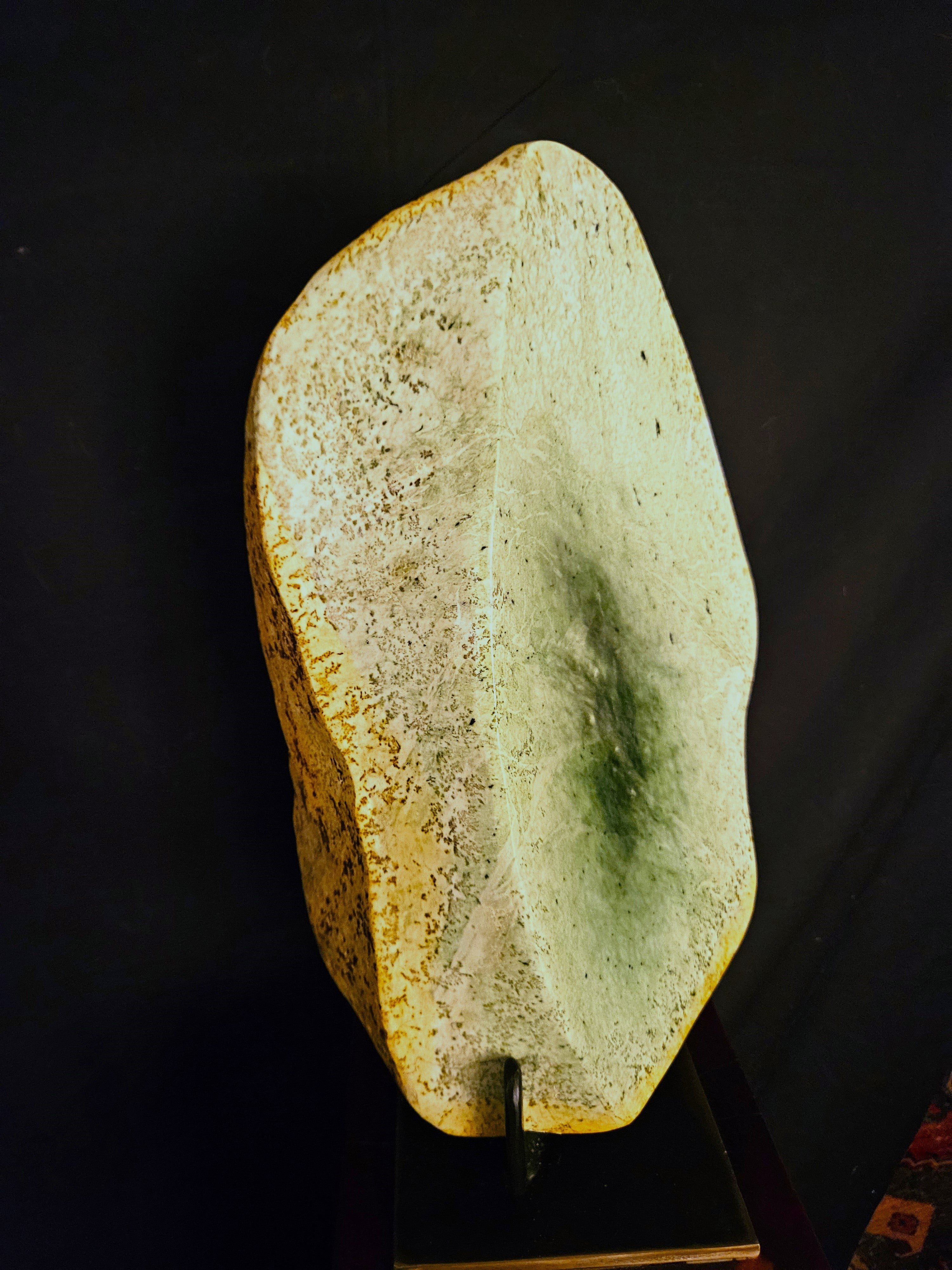 Freeform jade sculpture mounted on hardwood plinth