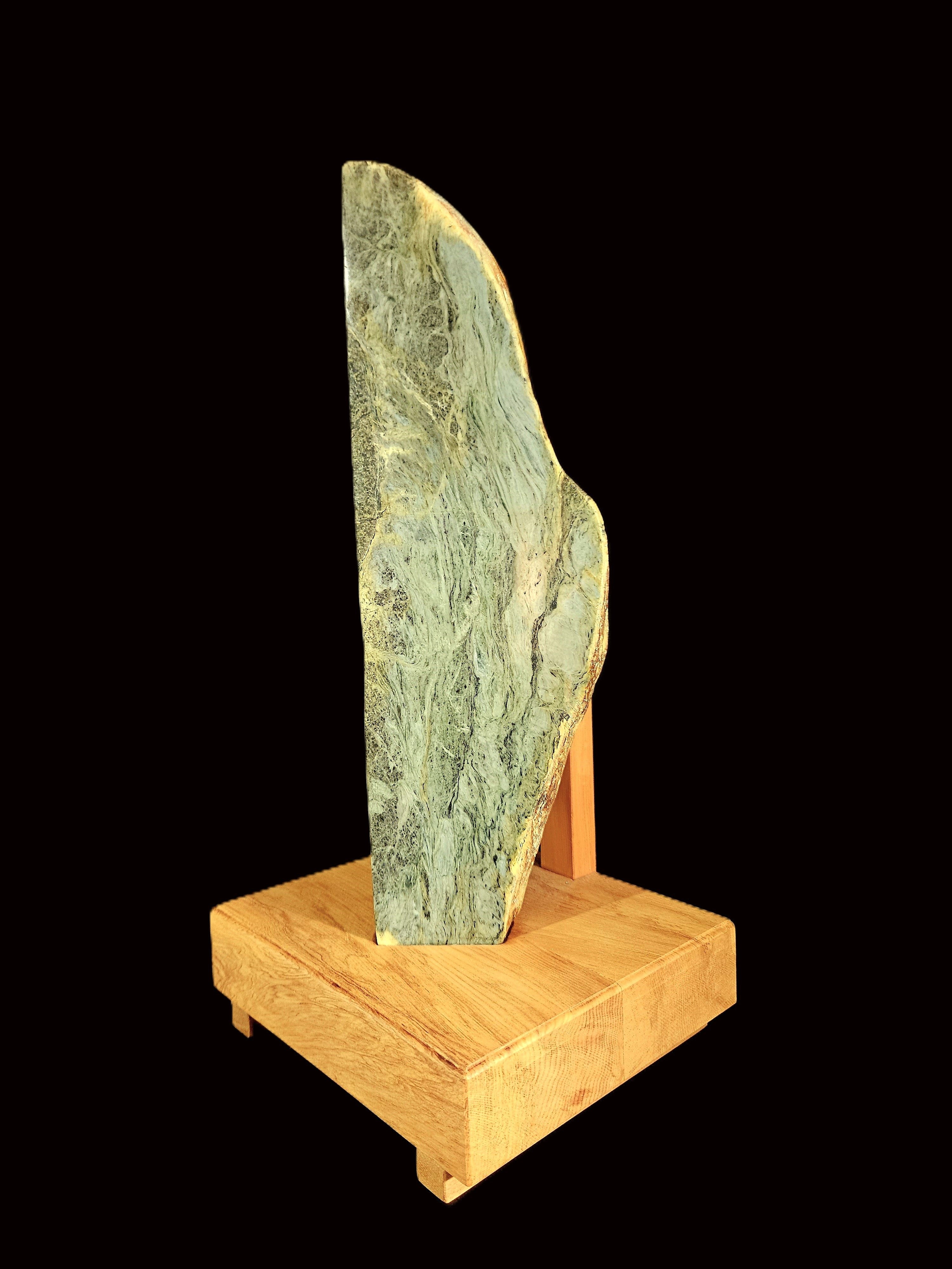 Freeform jade touchstone mounted on a rimu base