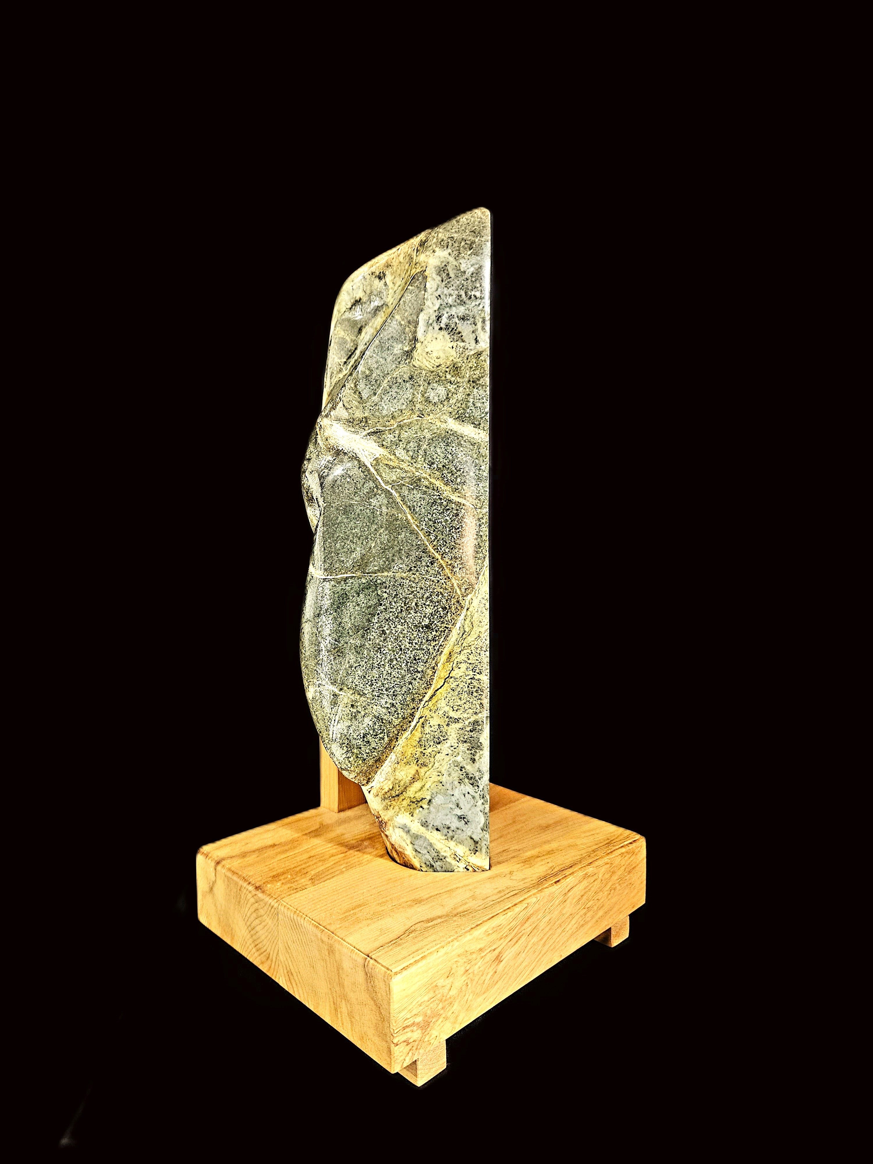 Freeform jade touchstone mounted on a rimu base