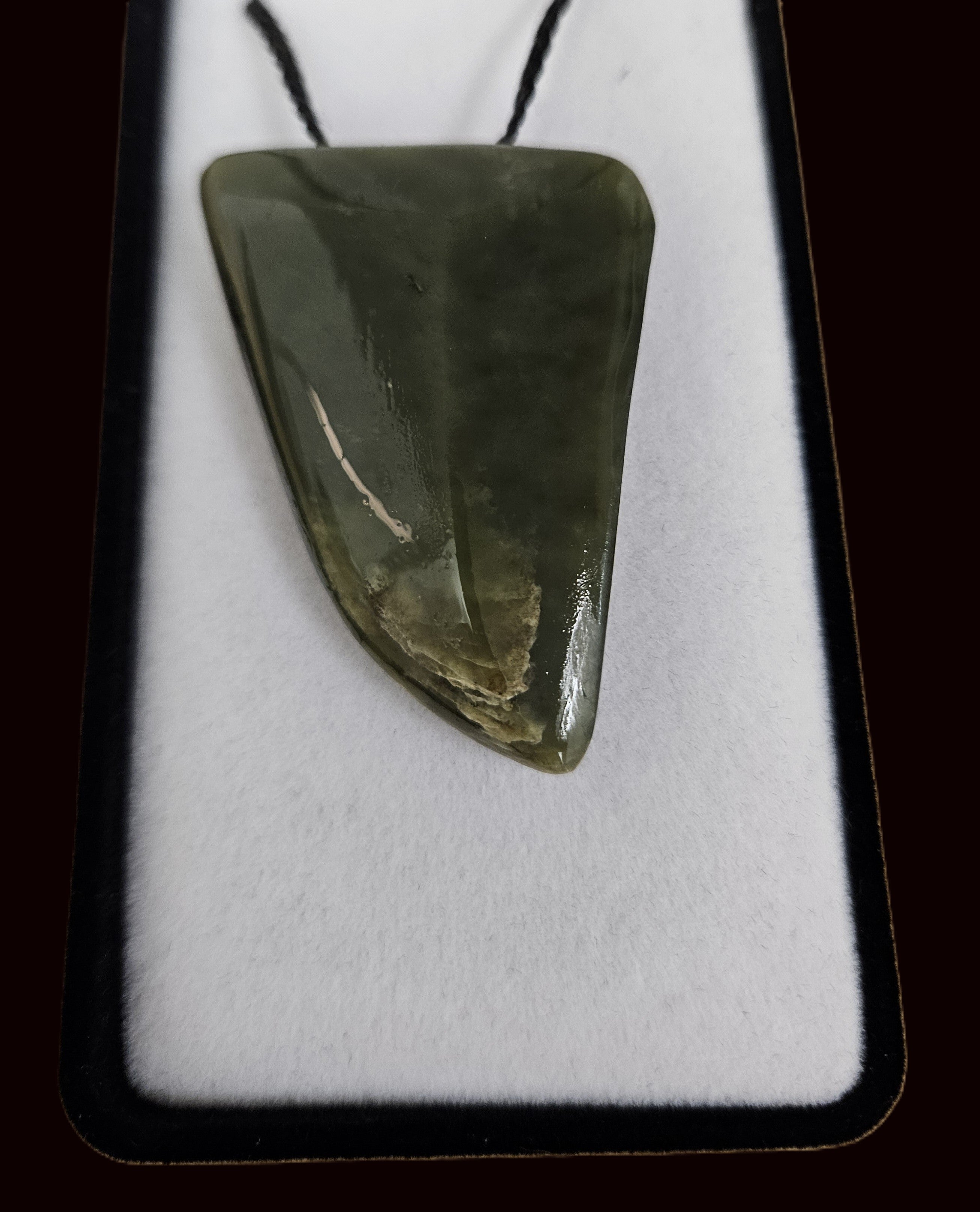 Stylised jade shark tooth pendant